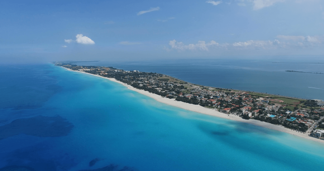varadero-cuba-may-25-2016-drone-flies-over-tropical-island-calm-atlantic-ocean-and-the-bay-flying-over-the-city-birds-eye-view-to-main-streets-of-the-city-houses-and-coastline_sgoibgu___F0000.png